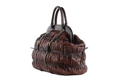Lot 146 - A Prada brown ruched Nappa leather holdall,...