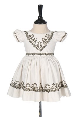 Lot 74 - A little girl's white cotton dress trimmed...