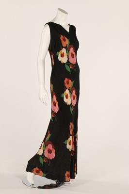 Lot 23 - A printed black lamé evening gown, circa 1930,...