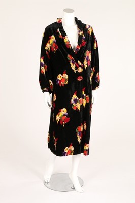 Lot 26 - A floral printed black velvet evening coat,...