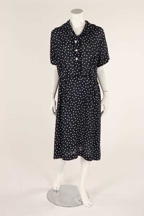 Lot 54 - A navy blue and white polka dot dress, early...