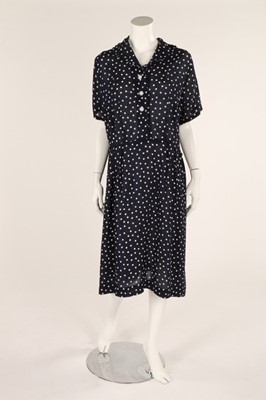 Lot 54 - A navy blue and white polka dot dress, early...