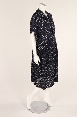 Lot 54 - A navy blue and white polka dot dress, early...