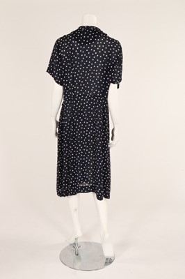 Lot 54 - A navy blue and white polka dot dress, early...