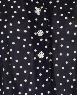 Lot 54 - A navy blue and white polka dot dress, early...