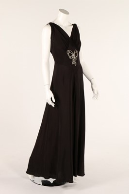 Lot 73 - A black crepe evening dress, 1940s, with...