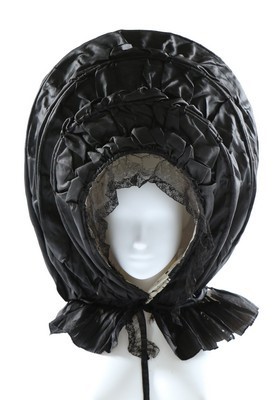 Lot 48 - A large black silk calche bonnet, circa 1770,...