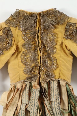 Lot 38 - A yellow silk jacket trimmed with metal lace,...