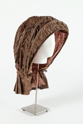 Lot 57 - A brown glazed cotton calche bonnet, circa...