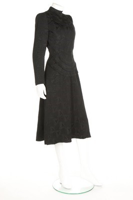 Lot 97 - A Schiaparelli black wool damask dinner dress,...