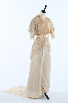 Lot 145 - A tapelace appliqued and ivory silk bridal...