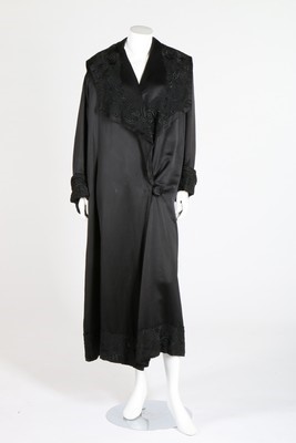 Lot 146 - A Peter Robinson black satin evening coat...