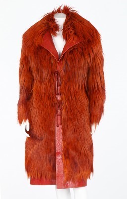 Lot 243 - A dyed orange fur coat, 1970s, edged in...