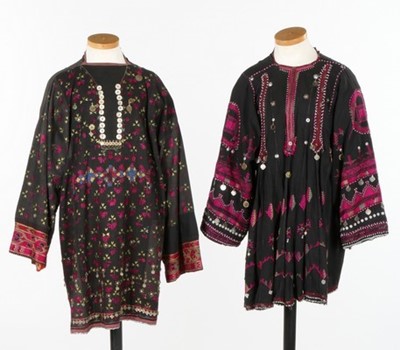 Lot 468 - Two embroidered and beaded black cotton smocks,...