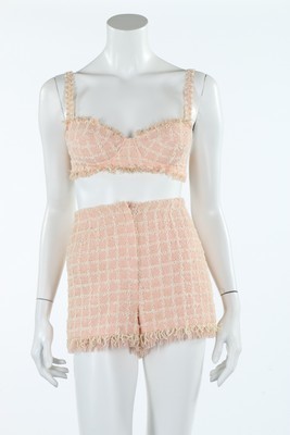 Lot 400 - A Chanel pink and white bouclé bra and shorts...