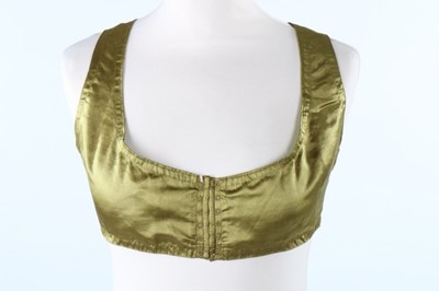 Lot 404 - An olive green satin bodice, circa 1810, with...