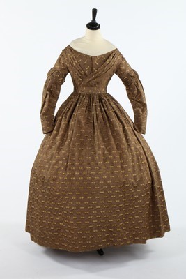 Lot 417 - A brown and yellow figured silk gown, late...