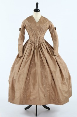 Lot 418 - A golden-brown silk dress, circa 1840, rows of...