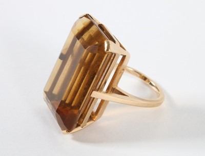 Lot 310 - A large smokey quartz emerald cut gold ring,...