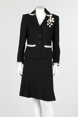 Lot 12 - A Chanel black wool suit with white satin...