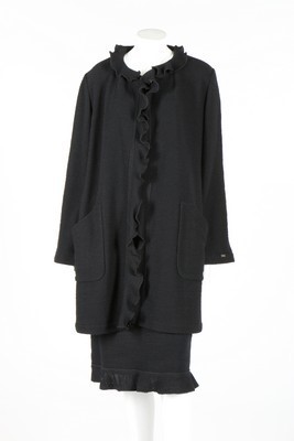 Lot 21 - A Chanel black tweed suit, 1999, labelled and...