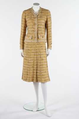 Lot 35 - A Chanel couture yellow tweed suit, late 1960s-...
