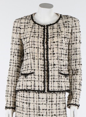 Lot 31 - A Chanel black and cream tweed suit, 2003,...