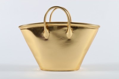 Lot 224 - A Comme des Garons bucket-shaped gold vinyl...