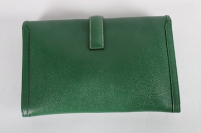 Lot 13 - An Hermès green leather pochette, stamped...
