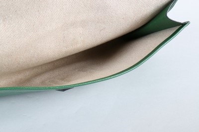 Lot 13 - An Hermès green leather pochette, stamped...