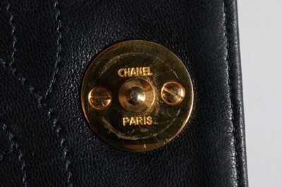 Lot 14 - A Chanel quilted navy leather bag, stamped to...