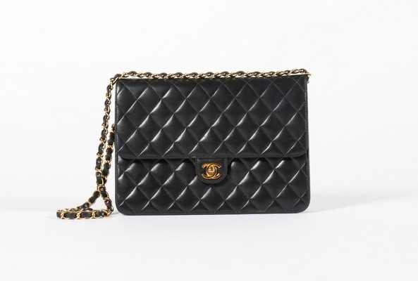 Lot 23 - A Chanel quilted navy leather bag, stamped to...