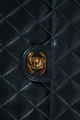 Lot 23 - A Chanel quilted navy leather bag, stamped to...