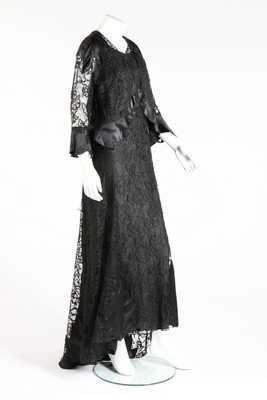 Lot 70 - A Worth-labelled black lace and ciré satin...