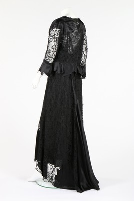Lot 70 - A Worth-labelled black lace and ciré satin...