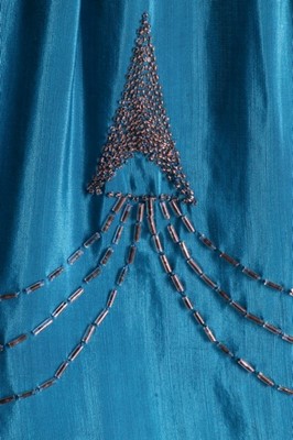 Lot 111 - A petrol-blue crepe dress with silver beading...