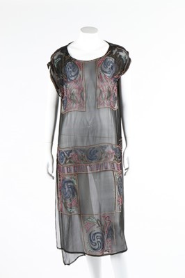 Lot 112 - A beaded black crepe flapper dress and similar...