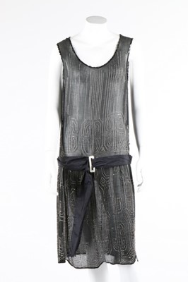 Lot 112 - A beaded black crepe flapper dress and similar...