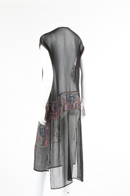 Lot 112 - A beaded black crepe flapper dress and similar...