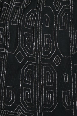 Lot 112 - A beaded black crepe flapper dress and similar...