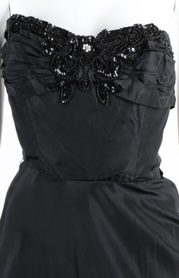 Lot 115 - Black and white evening gowns, including a...