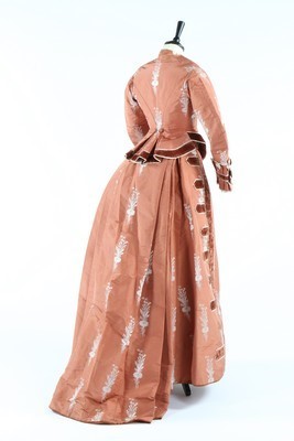 Lot 132 - A brocaded cinnamon taffeta gown, circa 1876,...