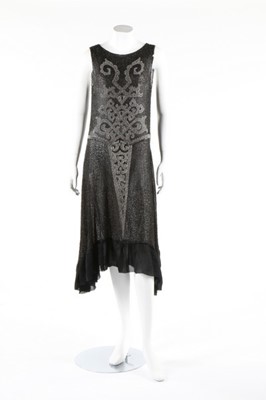 Lot 135 - A beaded black muslin flapper dress, circa...