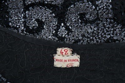 Lot 135 - A beaded black muslin flapper dress, circa...