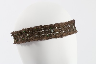 Lot 184 - A good group of headwear and haircombs,...