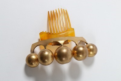 Lot 184 - A good group of headwear and haircombs,...