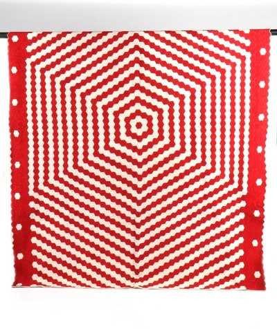 Lot 194 - A scarlet and red hexagonal patchwork quilt,...