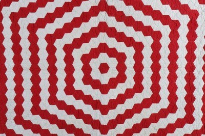 Lot 194 - A scarlet and red hexagonal patchwork quilt,...