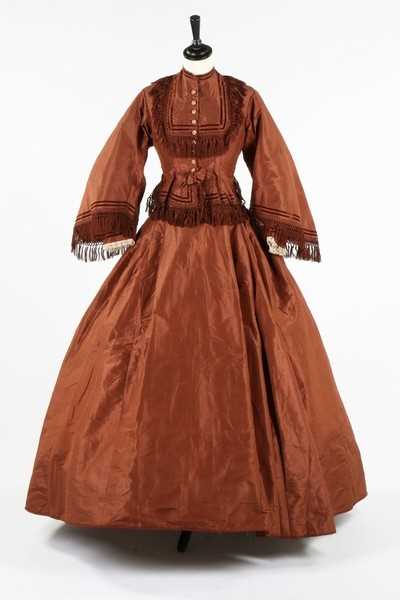 Lot 212 - A brown taffeta day dress circa 1870, the...