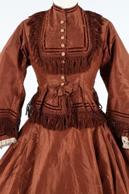 Lot 212 - A brown taffeta day dress circa 1870, the...